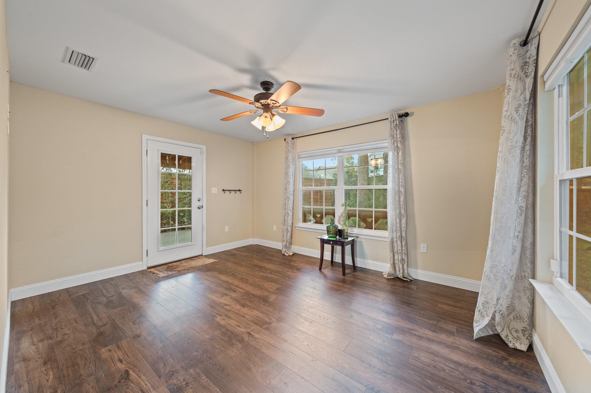 1825 Huntington Road Niceville, FL 32578 - Photo 20 of 68 a view of an empty room with a window and wooden floor