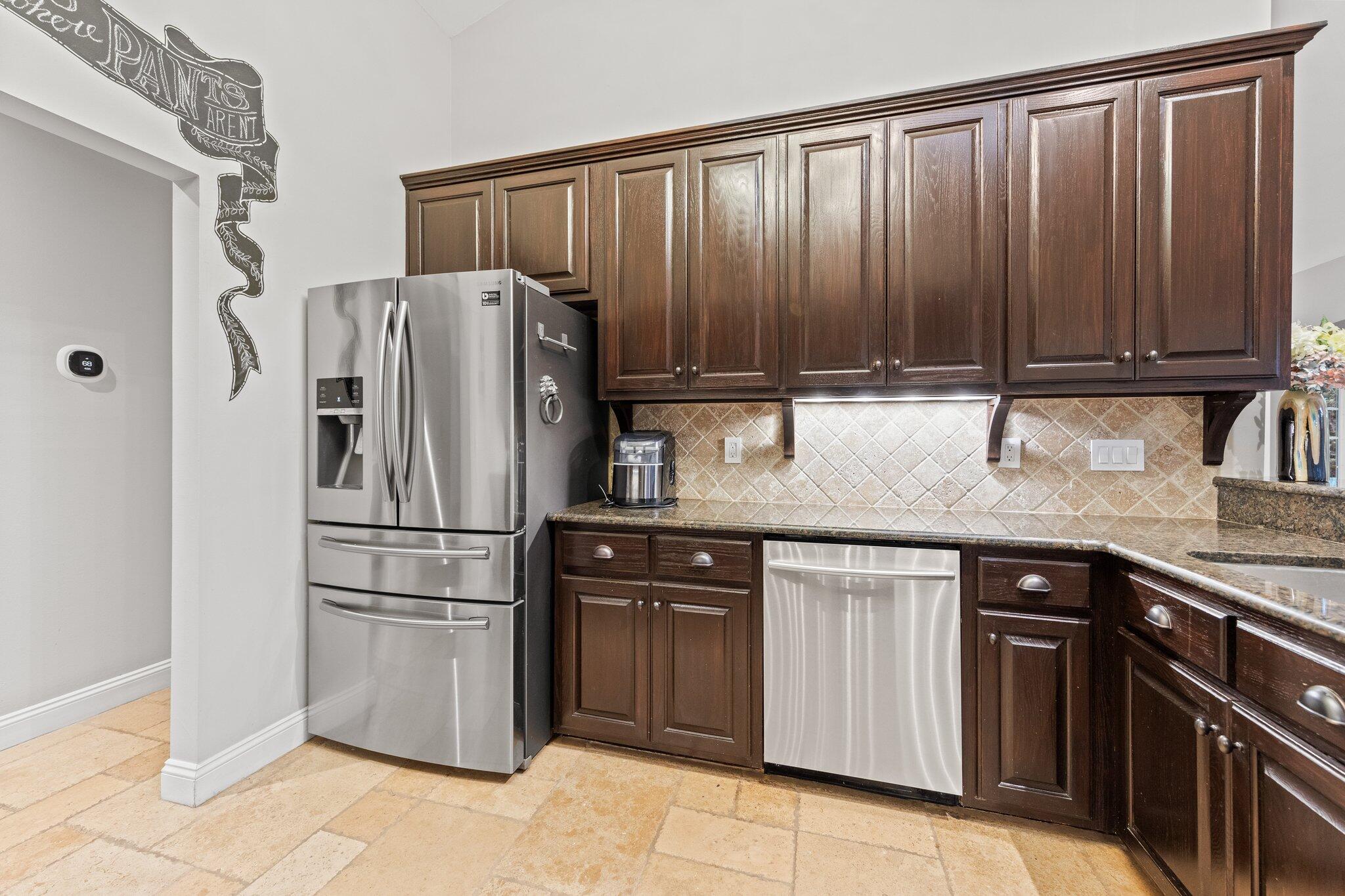 1825 Huntington Road Niceville, FL 32578 - Photo 27 of 68 a kitchen with granite countertop a refrigerator and a sink