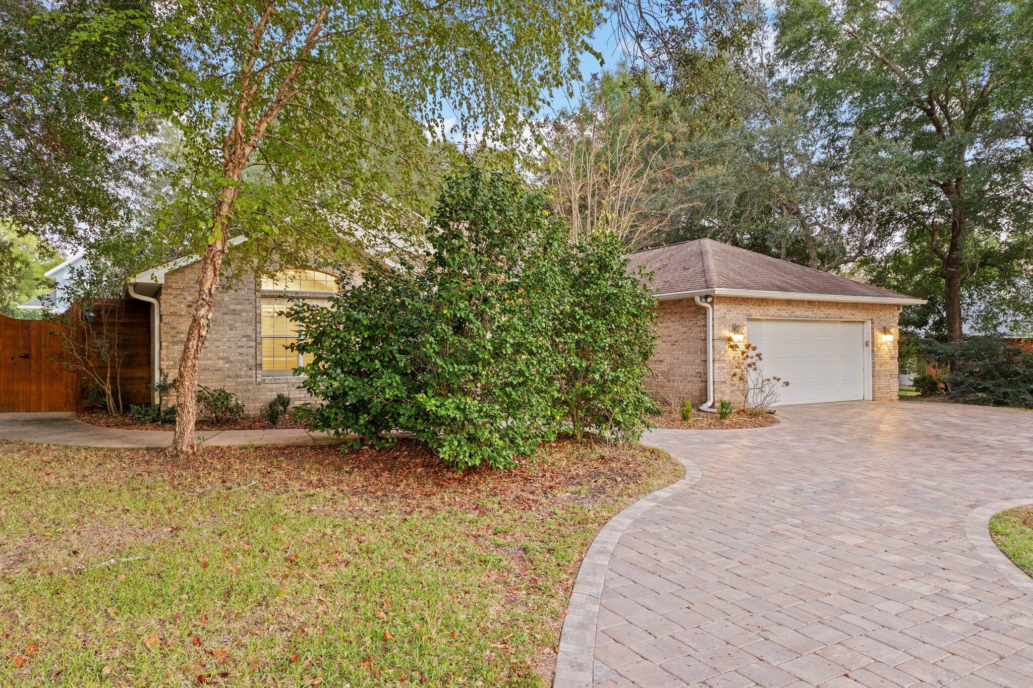 1825 Huntington Road Niceville, FL 32578 - Photo 3 of 68 a front view of a house with a yard and garage