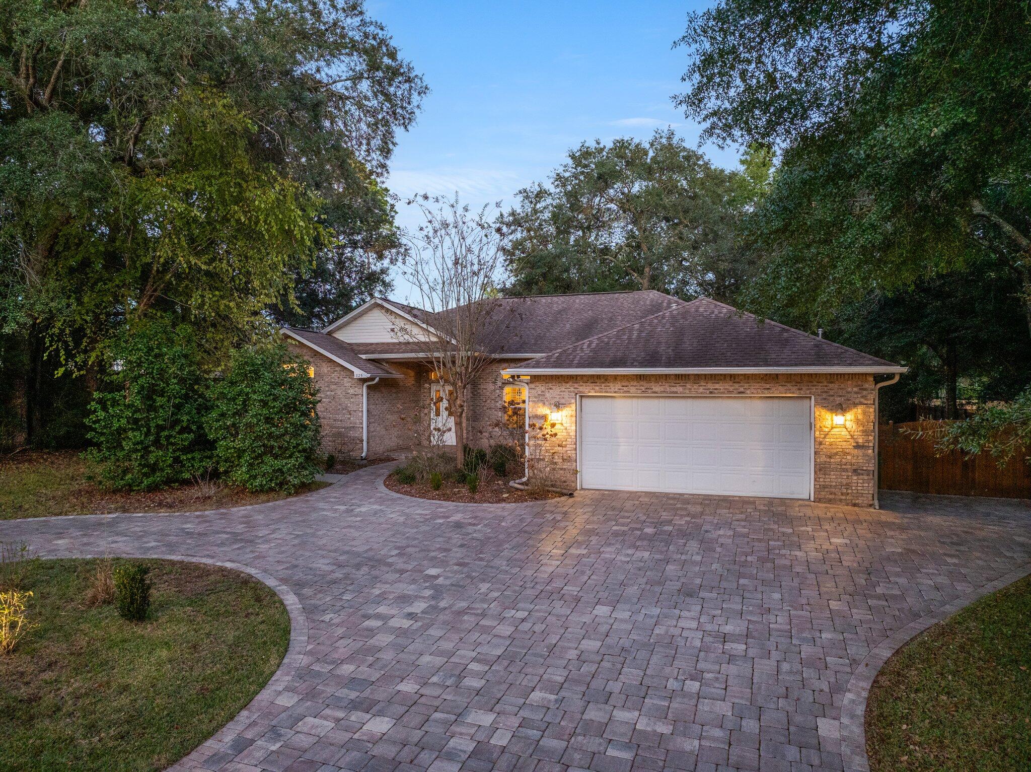 1825 Huntington Road Niceville, FL 32578 - Photo 9 of 68 a front view of a house with a yard and garage