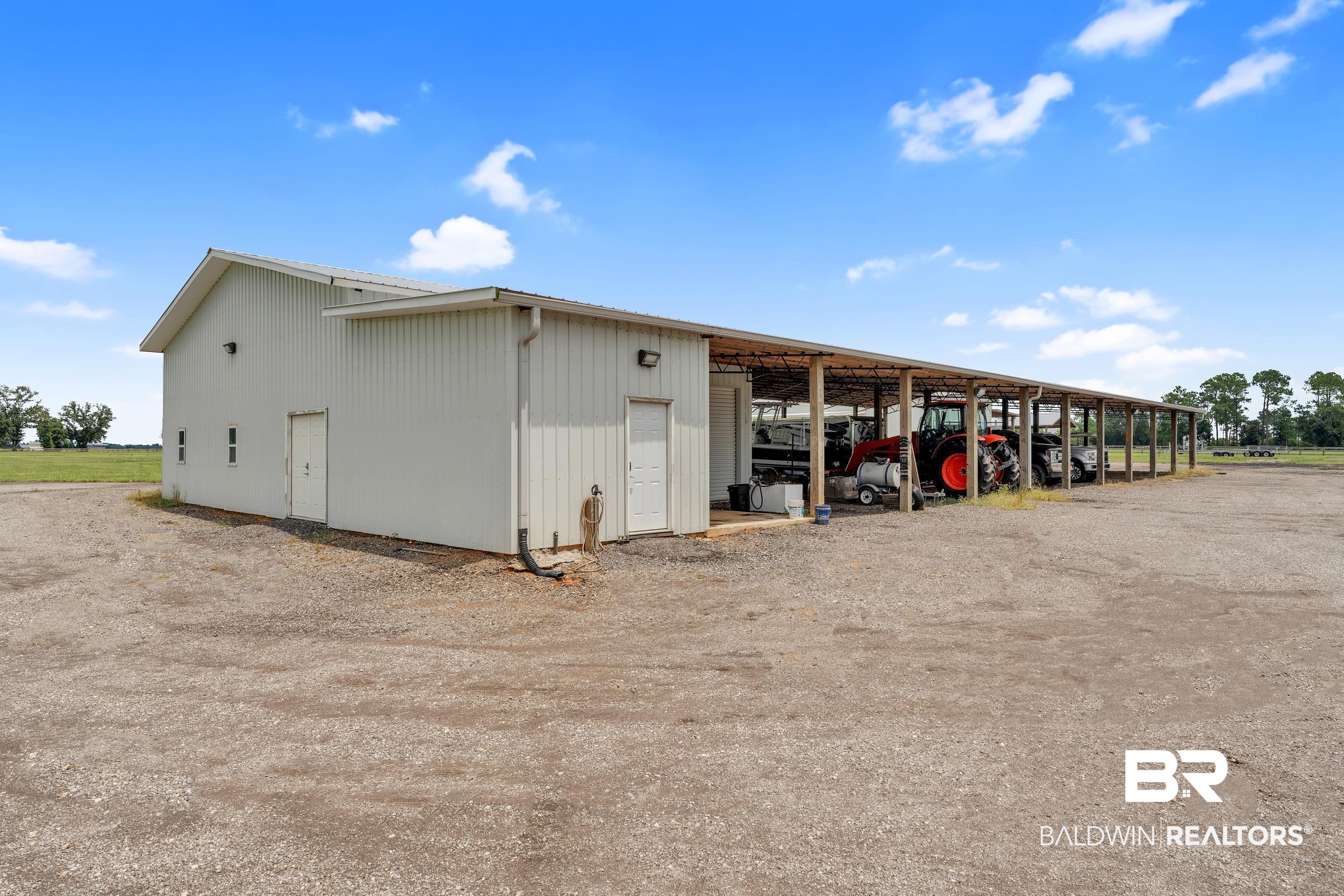 22592 Pastoral Lane Foley, AL 36535 - Photo 31 of 45 View of pole building featuring a carport