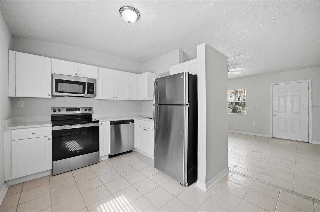 6629 Sierra Terrace New Port Richey, FL 34652 - Photo 5 of 30 a kitchen with a refrigerator sink and stove top oven