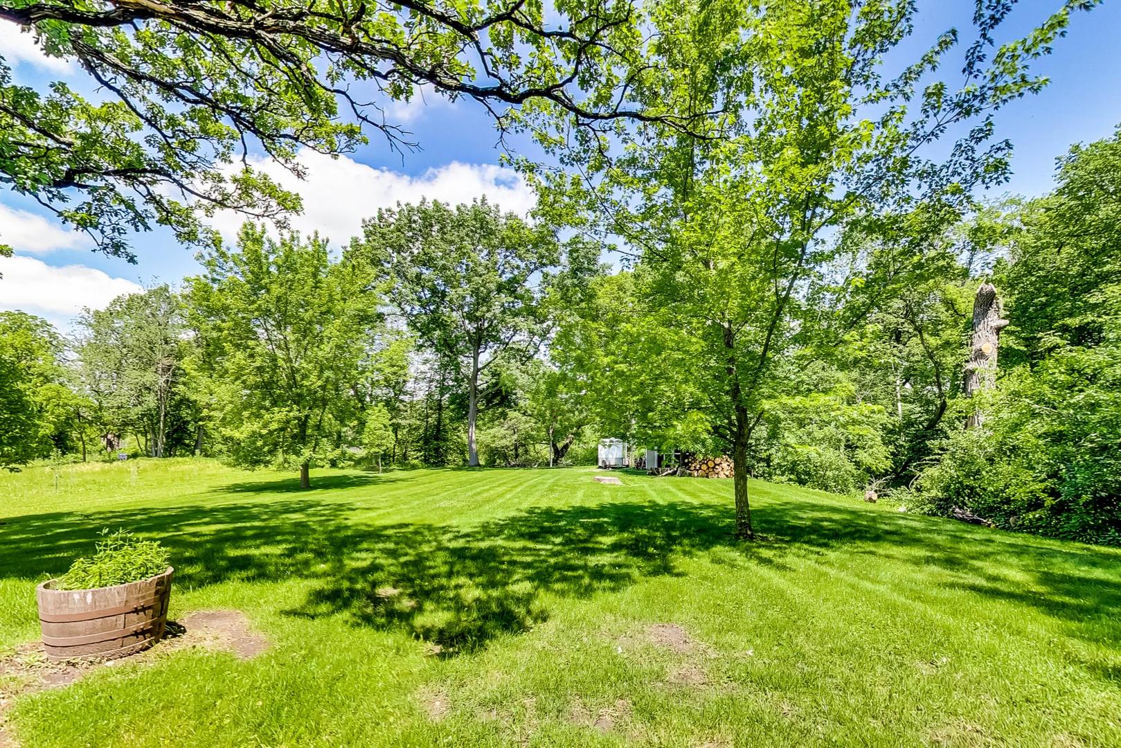 3814 May Lane Spring Grove, IL 60081 - Photo 4 of 18 a view of a grassy field with trees
