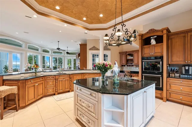 a kitchen with stainless steel appliances granite countertop a sink and a refrigerator