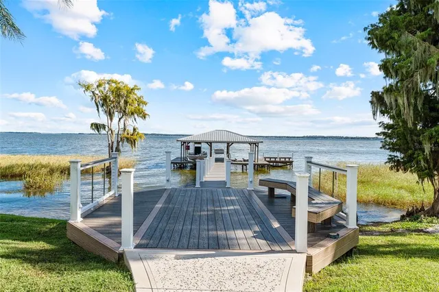 an aerial view of residential house with outdoor space and trees all around