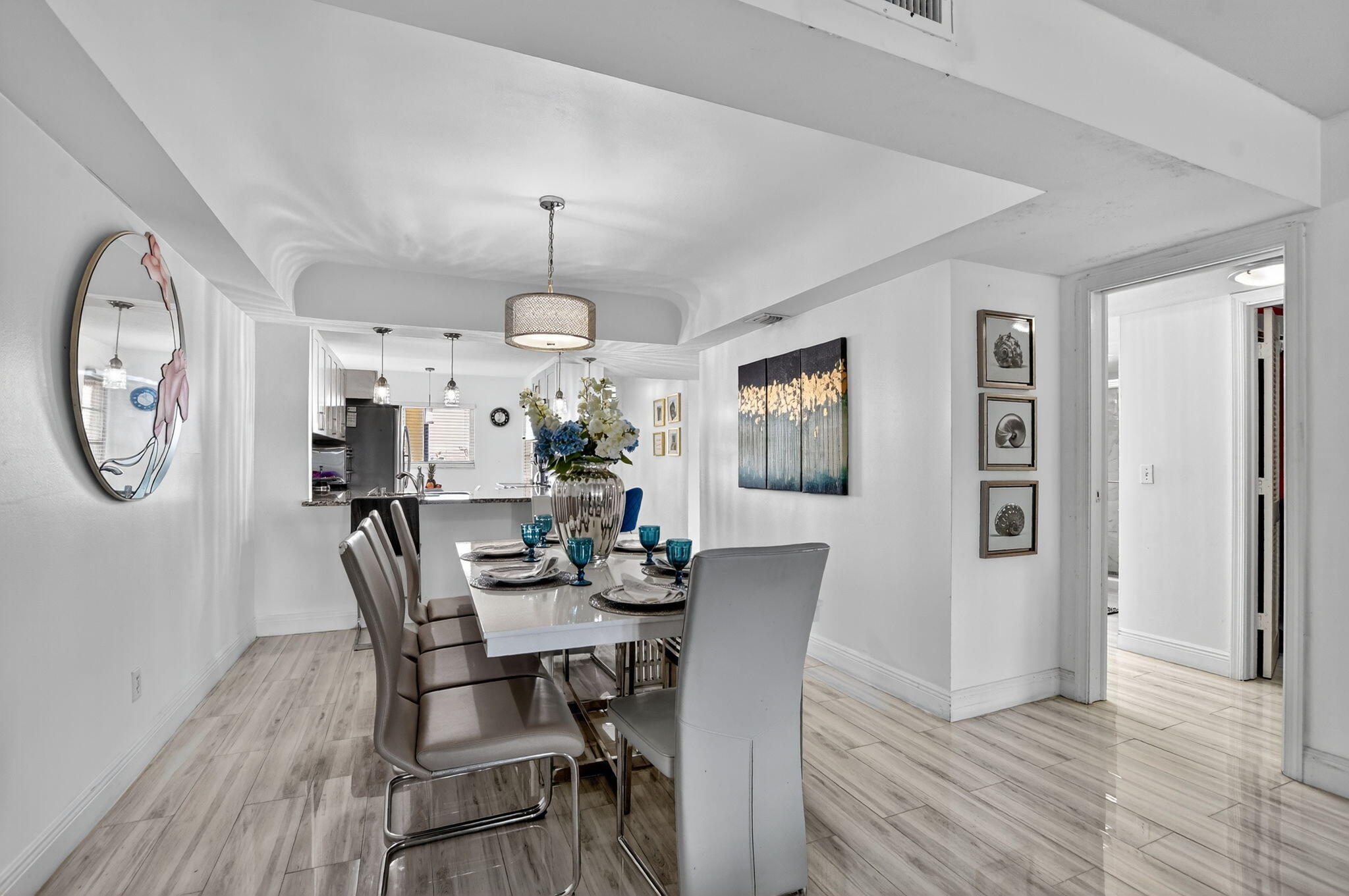 23277 Barwood Lane North, Unit 403 Boca Raton, FL 33428 - Photo 11 of 30 a view of a dining room with furniture and a chandelier