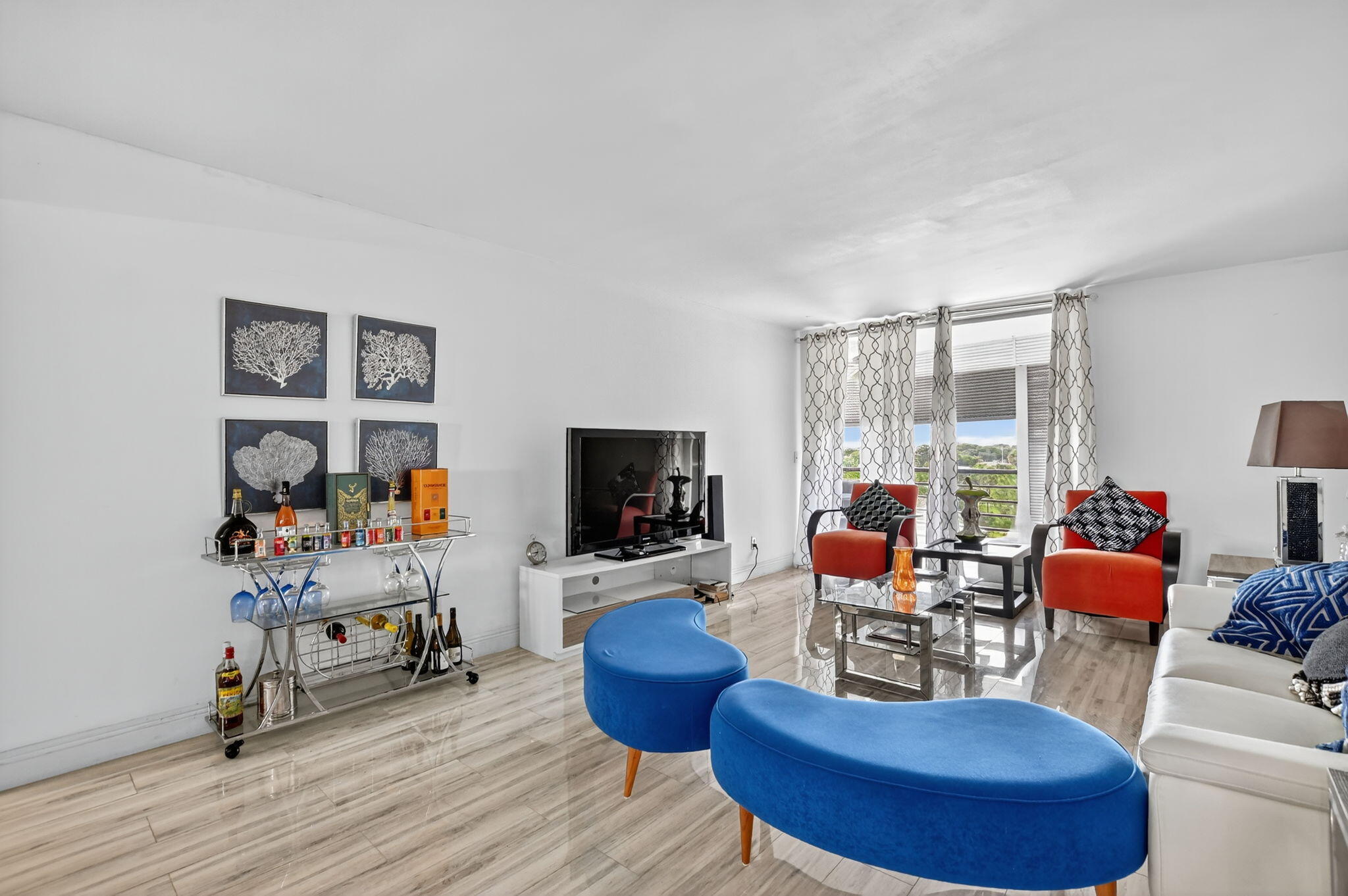 23277 Barwood Lane North, Unit 403 Boca Raton, FL 33428 - Photo 12 of 30 a living room with furniture and a flat screen tv