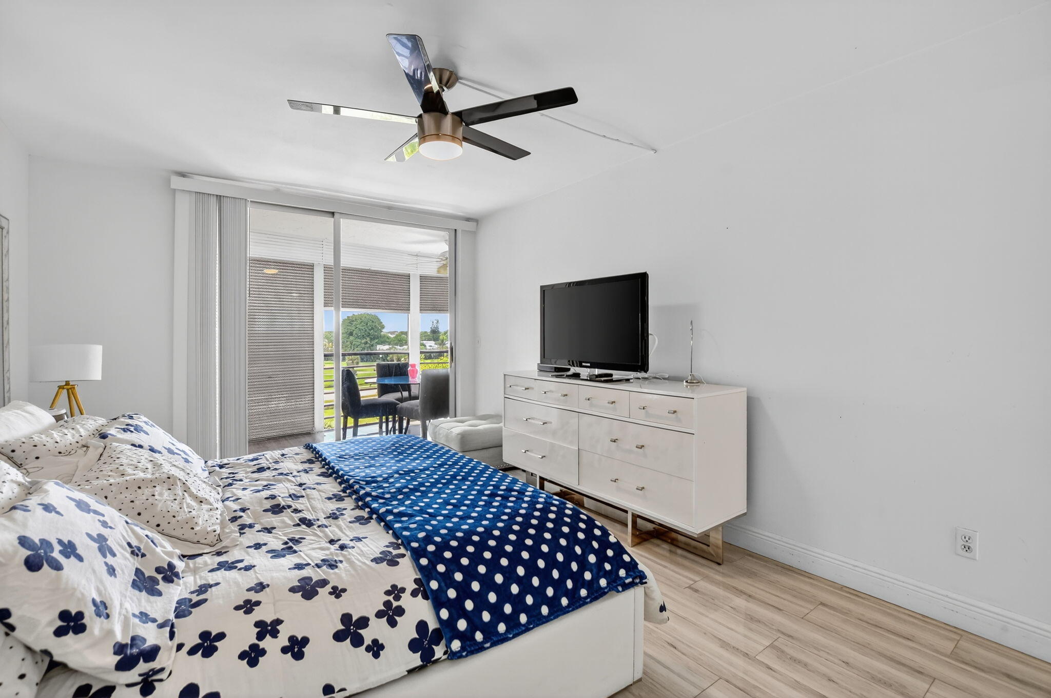 23277 Barwood Lane North, Unit 403 Boca Raton, FL 33428 - Photo 17 of 30 a bedroom with a bed and a flat screen tv