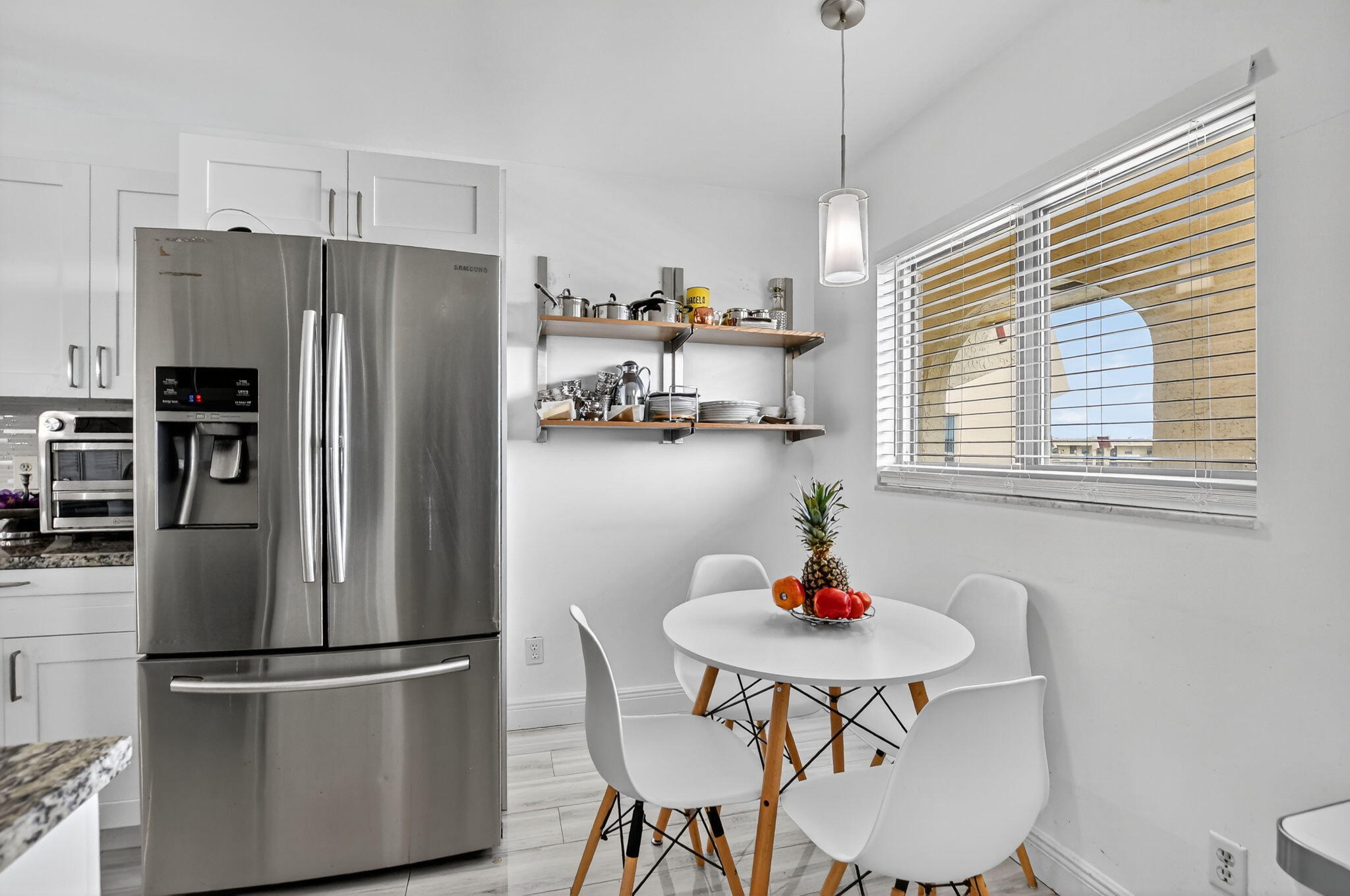 23277 Barwood Lane North, Unit 403 Boca Raton, FL 33428 - Photo 2 of 30 a kitchen with refrigerator and wooden floor