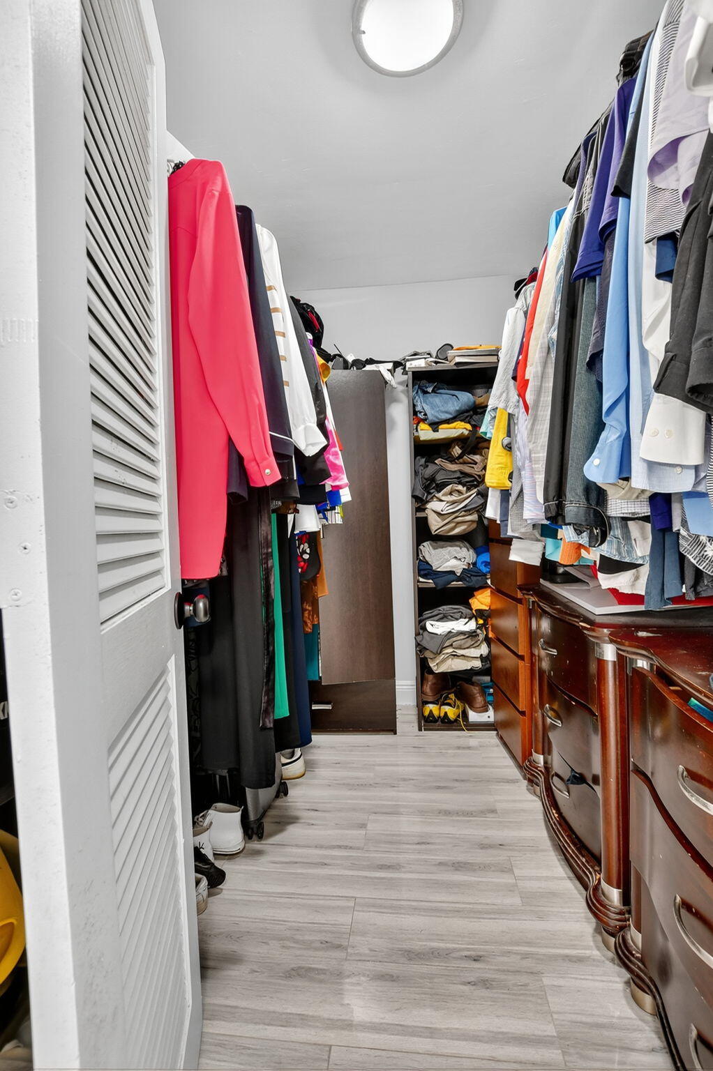 23277 Barwood Lane North, Unit 403 Boca Raton, FL 33428 - Photo 21 of 30 a view of walk in closet with clothes and shoes