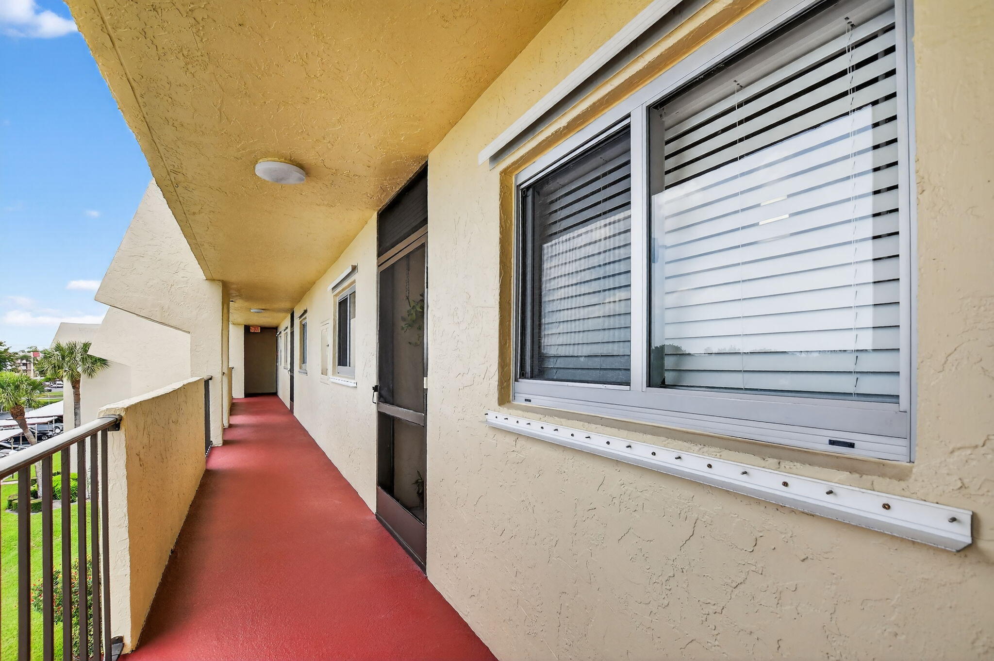 23277 Barwood Lane North, Unit 403 Boca Raton, FL 33428 - Photo 28 of 30 a view of a balcony with wooden floor and stairs