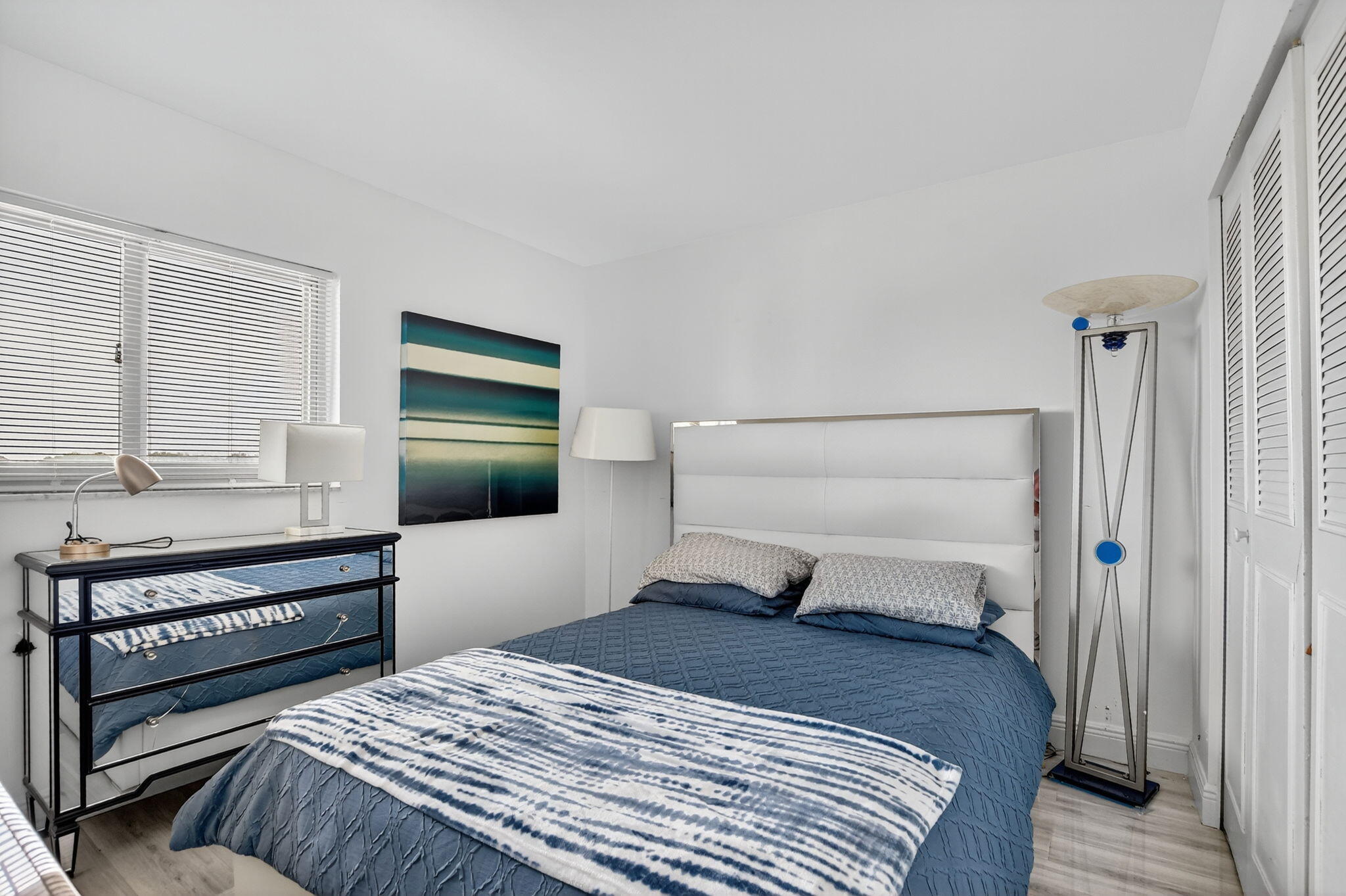 23277 Barwood Lane North, Unit 403 Boca Raton, FL 33428 - Photo 5 of 30 a bedroom with a bed and a flat screen tv