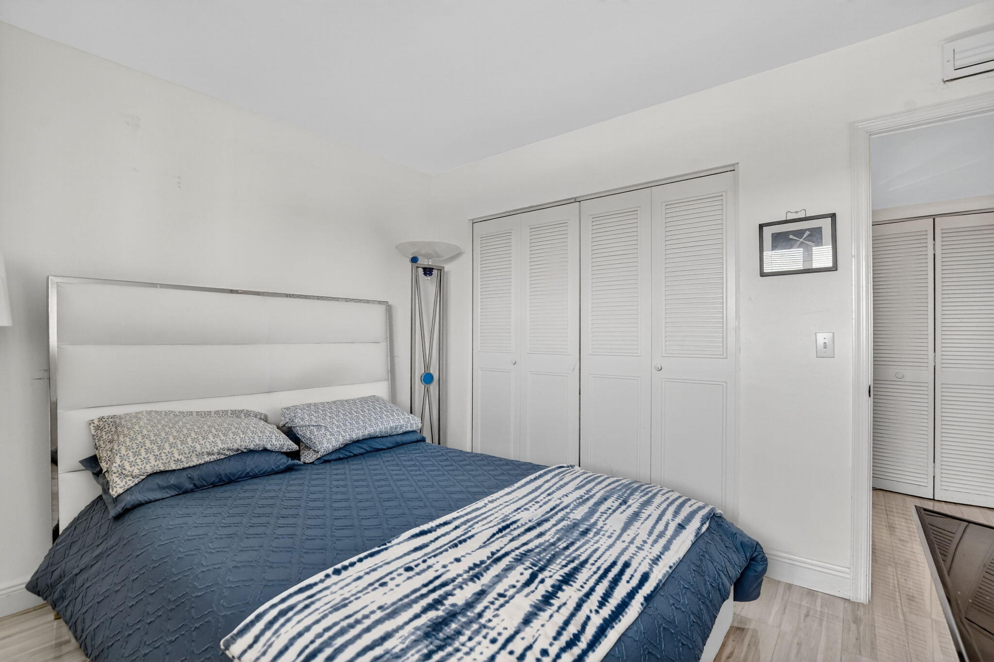 23277 Barwood Lane North, Unit 403 Boca Raton, FL 33428 - Photo 6 of 30 a bedroom with a bed and a mirror