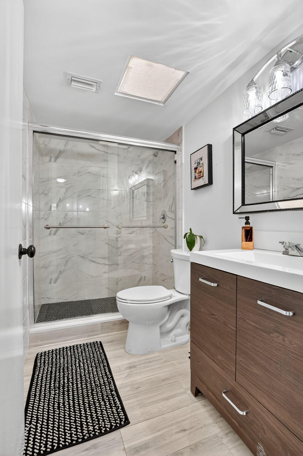 23277 Barwood Lane North, Unit 403 Boca Raton, FL 33428 - Photo 8 of 30 a bathroom with a sink a toilet and shower