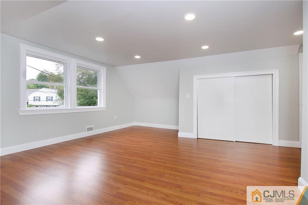 20 Phillips Road Edison, NJ 08817 - Photo 11 of 19 an empty room with wooden floor and windows