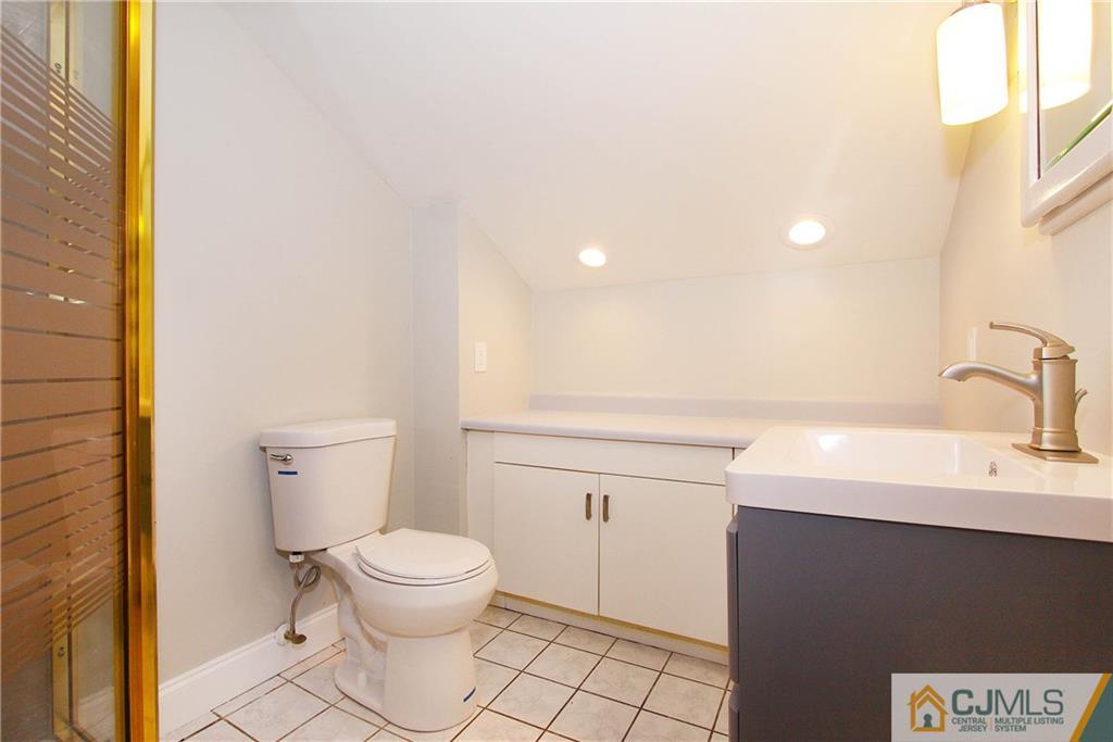 20 Phillips Road Edison, NJ 08817 - Photo 12 of 19 a bathroom with a sink a toilet and a mirror