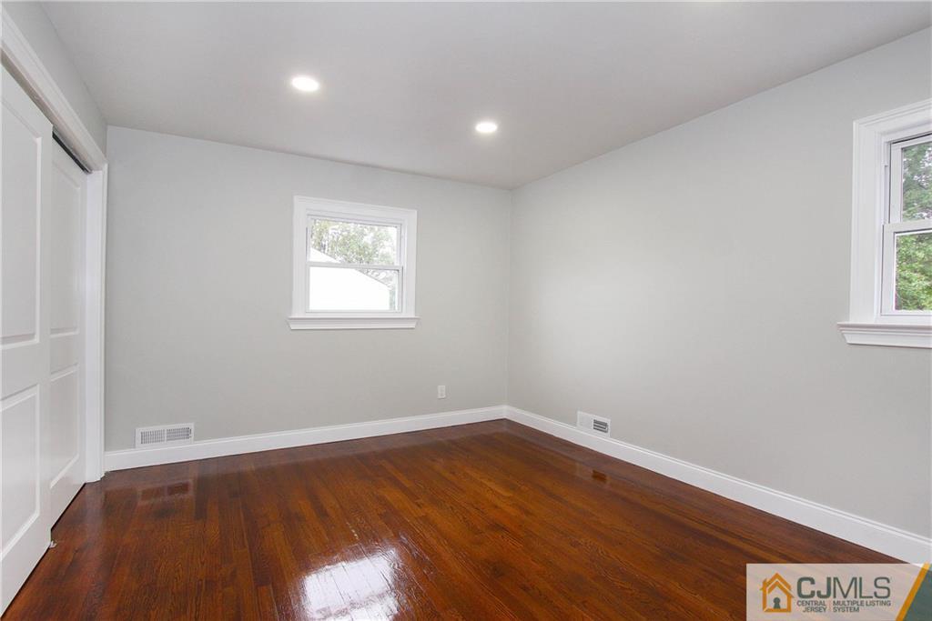 20 Phillips Road Edison, NJ 08817 - Photo 13 of 19 an empty room with wooden floor and windows