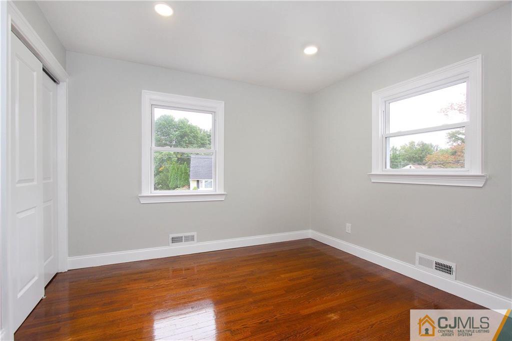 20 Phillips Road Edison, NJ 08817 - Photo 14 of 19 a view of an empty room with wooden floor and a window