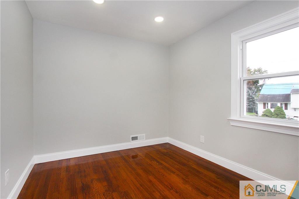 20 Phillips Road Edison, NJ 08817 - Photo 15 of 19 an empty room with wooden floor and windows
