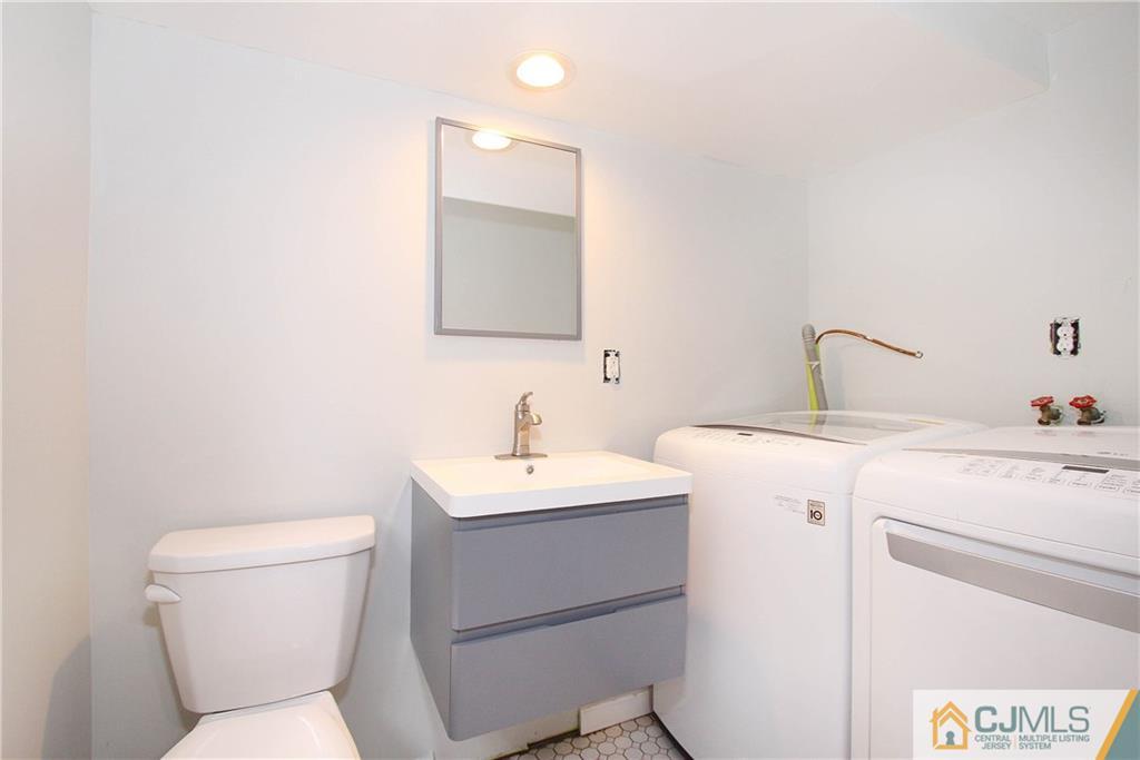 20 Phillips Road Edison, NJ 08817 - Photo 18 of 19 a bathroom with a toilet sink and mirror