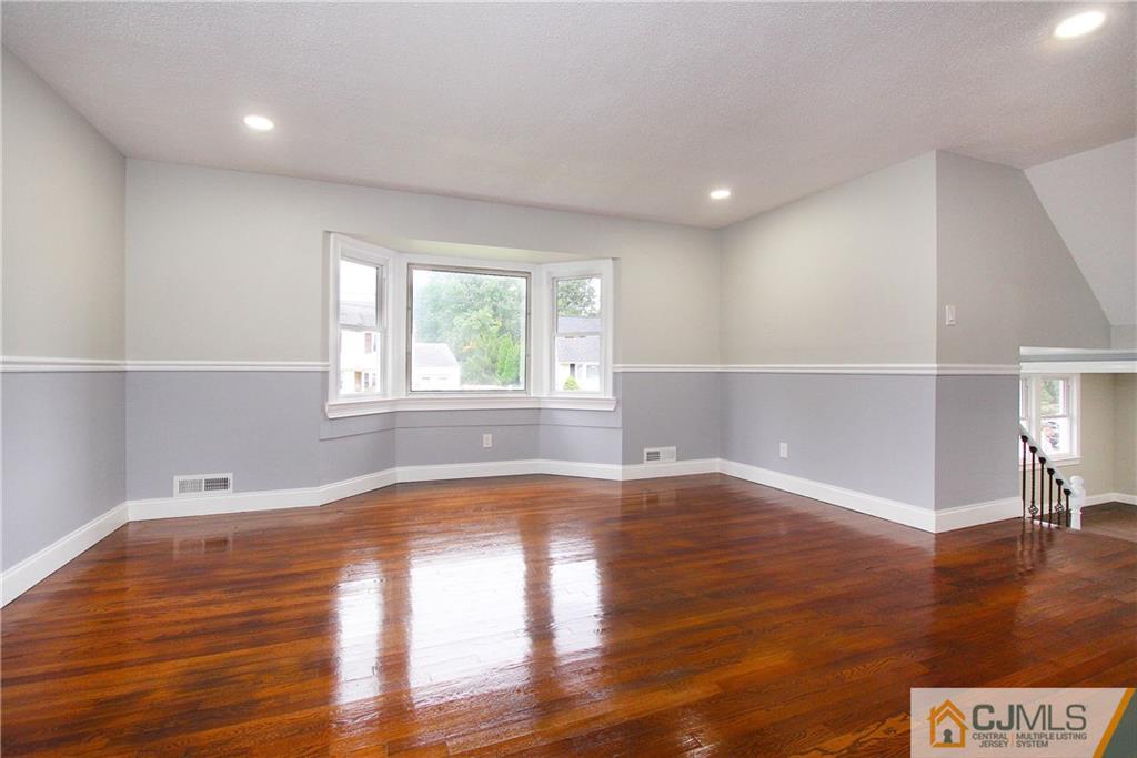 20 Phillips Road Edison, NJ 08817 - Photo 4 of 19 a view of empty room with wooden floor and fan
