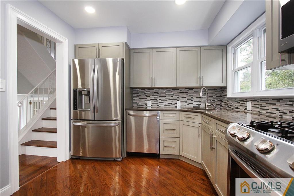 20 Phillips Road Edison, NJ 08817 - Photo 6 of 19 a kitchen with a refrigerator sink and white cabinets