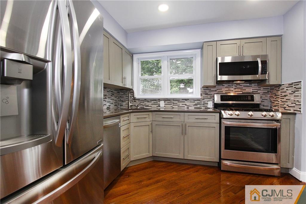 20 Phillips Road Edison, NJ 08817 - Photo 7 of 19 a kitchen with stainless steel appliances granite countertop a stove microwave and refrigerator