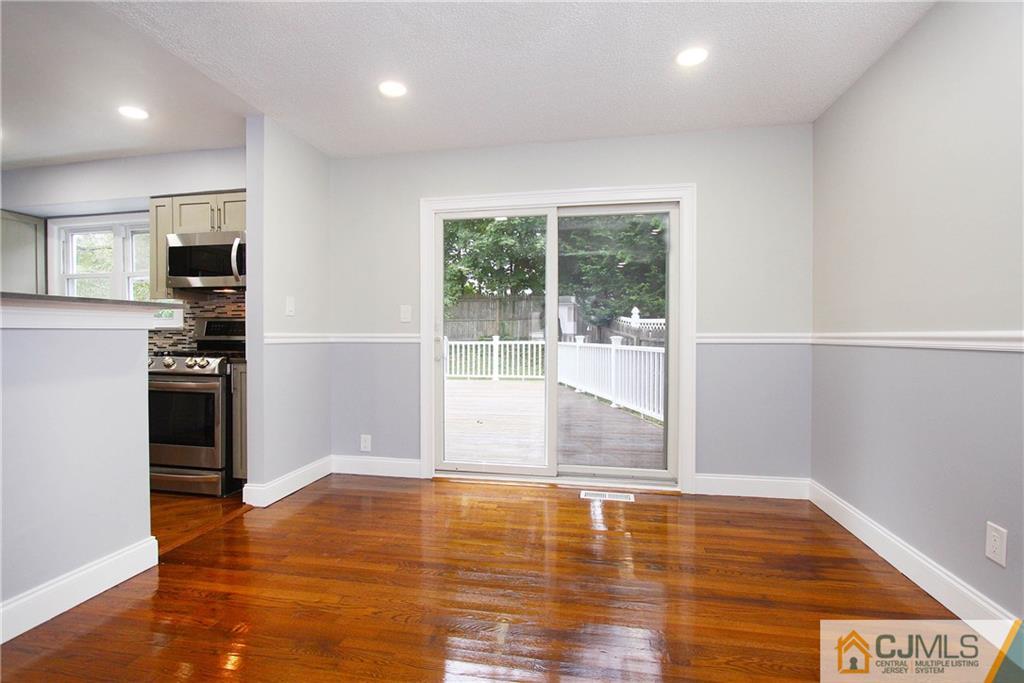 20 Phillips Road Edison, NJ 08817 - Photo 9 of 19 a view of empty room with wooden floor and fireplace