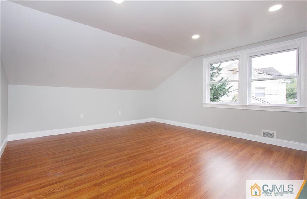20 Phillips Road Edison, NJ 08817 - Photo 10 of 19 an empty room with wooden floor and windows