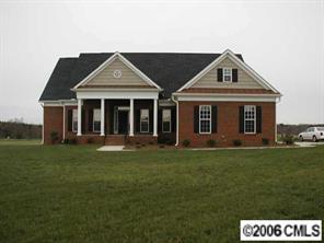 3104 East Lawyers Road Monroe, NC 28110 - Photo 1 of 7 a front view of a house with a garden