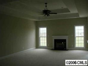 3104 East Lawyers Road Monroe, NC 28110 - Photo 3 of 7 a view of an empty room with a fireplace and a window