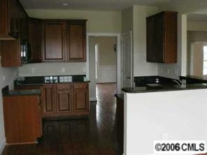 3104 East Lawyers Road Monroe, NC 28110 - Photo 4 of 7 a kitchen with a refrigerator and a stove top oven