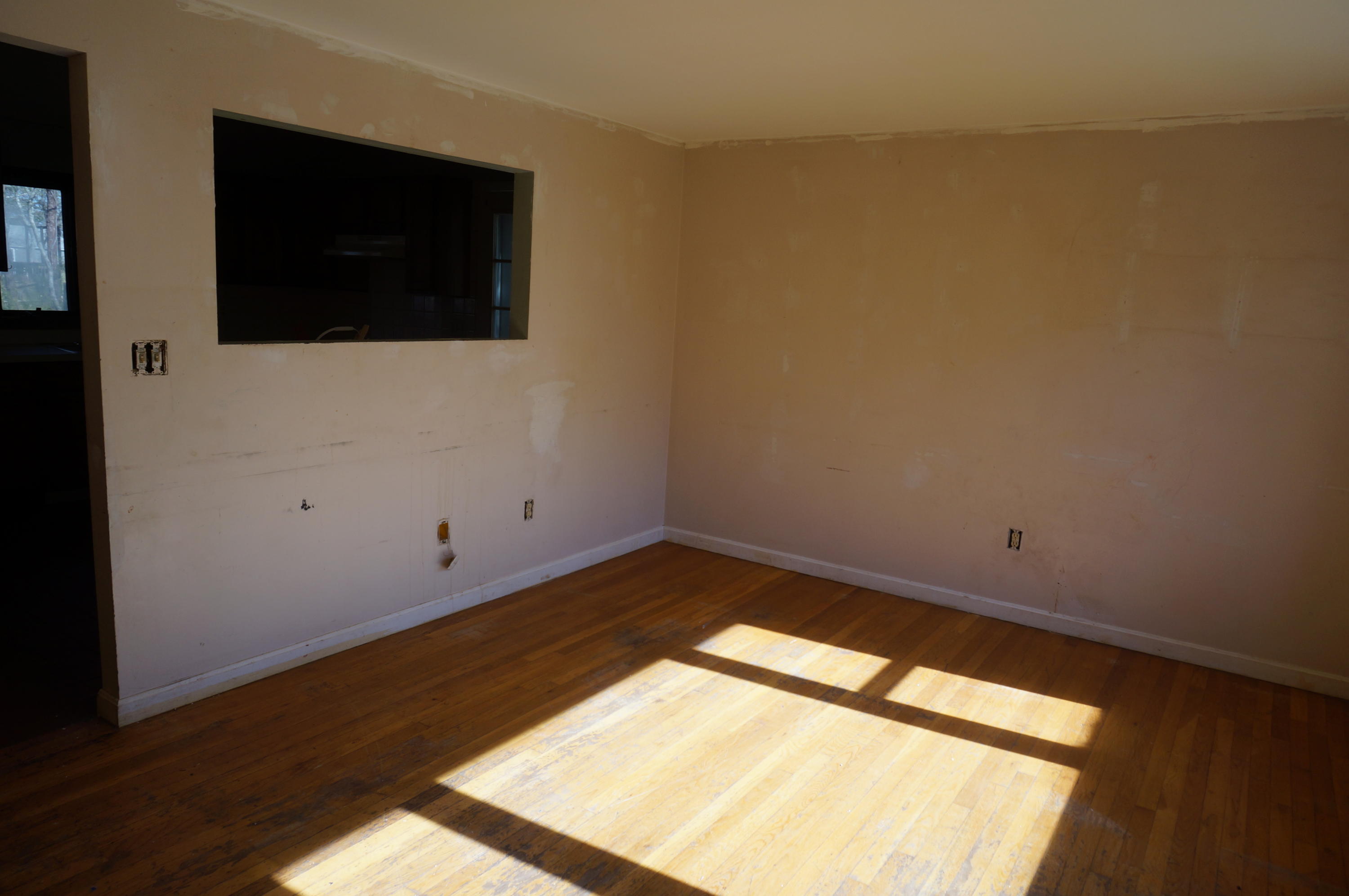 207 Hinckley Road Hyannis, MA 02601 - Photo 6 of 17 a view of an empty room with wooden floor and a window