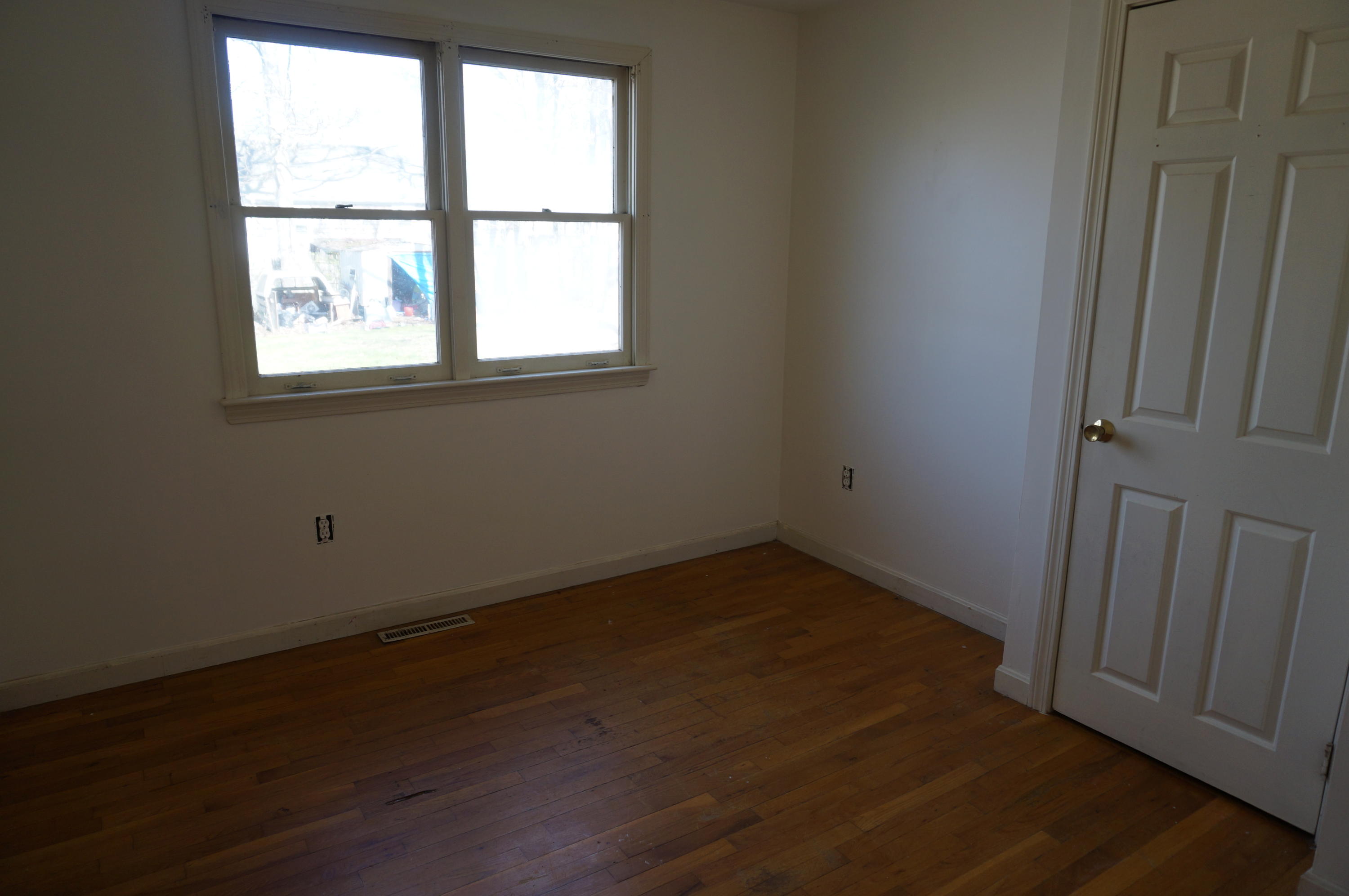 207 Hinckley Road Hyannis, MA 02601 - Photo 10 of 17 an empty room with wooden floor and windows