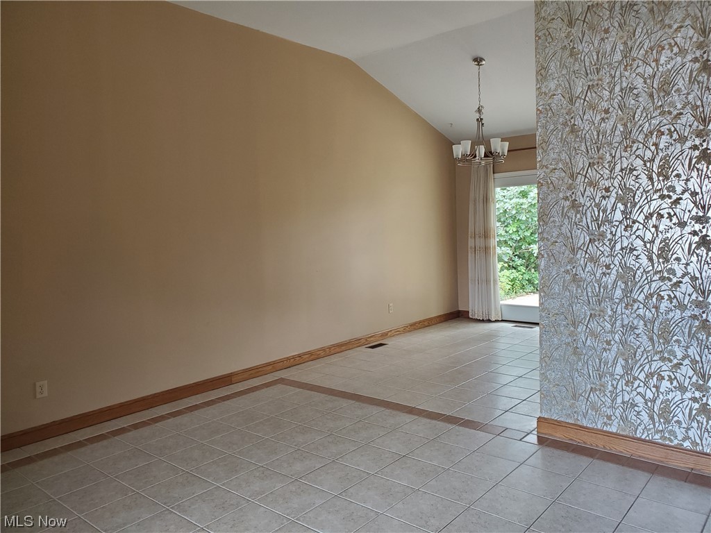 12221 Reno Drive Parma, OH 44130 - Photo 12 of 29 Tiled spare room featuring vaulted ceiling