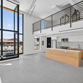 a large kitchen with stainless steel appliances granite countertop a stove and a refrigerator