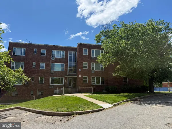 a view of a brick building next to a yard