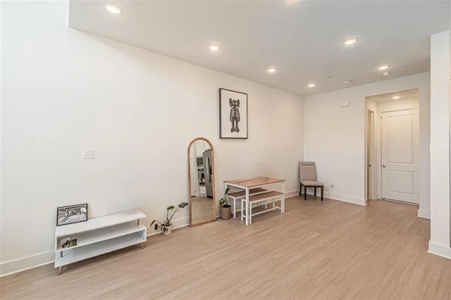 a view of a workspace with furniture and wooden floor