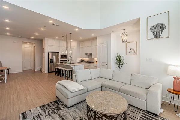a large kitchen with stainless steel appliances kitchen island granite countertop a large island in the center