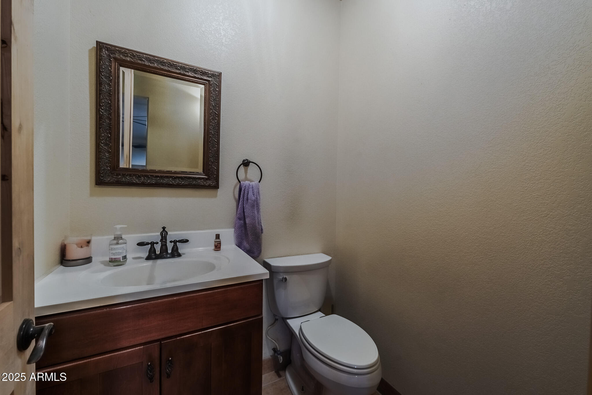 11003 North Hohokam Road Florence, AZ 85132 - Photo 21 of 90 a bathroom with a toilet sink vanity and mirror
