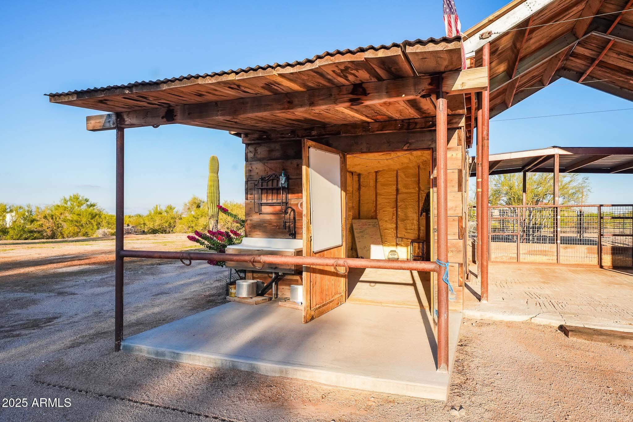 11003 North Hohokam Road Florence, AZ 85132 - Photo 41 of 90 a view of a patio with a table and chairs under an umbrella