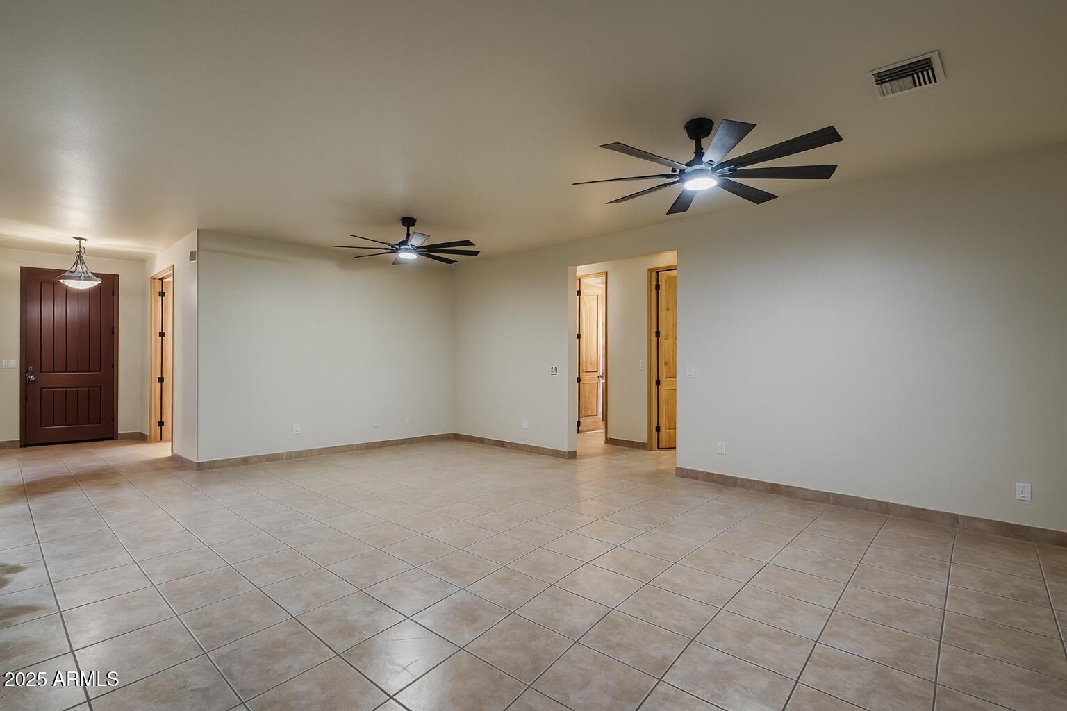 11003 North Hohokam Road Florence, AZ 85132 - Photo 7 of 90 an empty room with a ceiling fan and a window