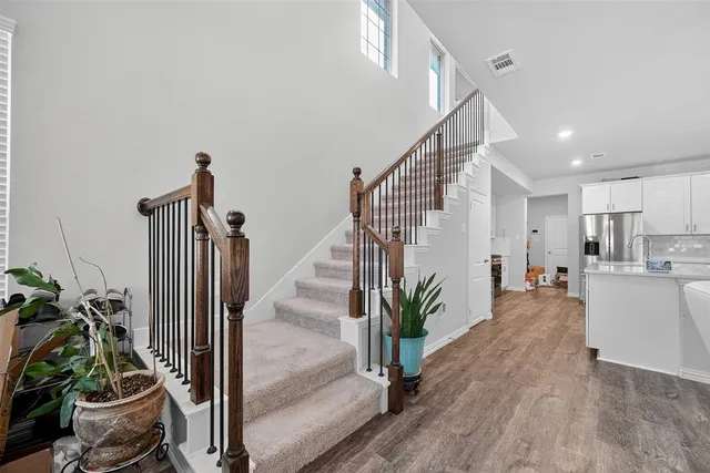 a view of an entryway with wooden floor and a livingroom view