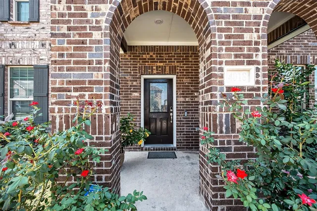 a view of a patio with a table and chairs and potted plants