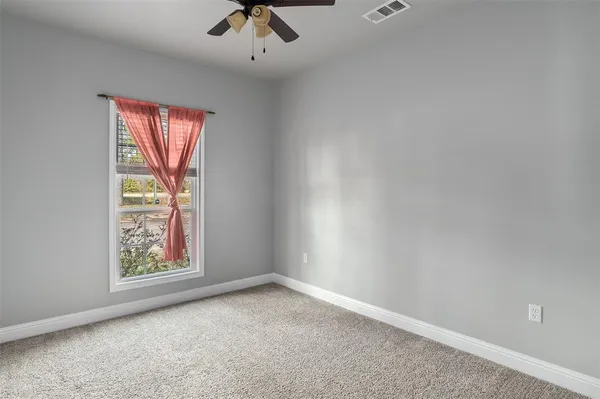 an empty room with windows and natural light