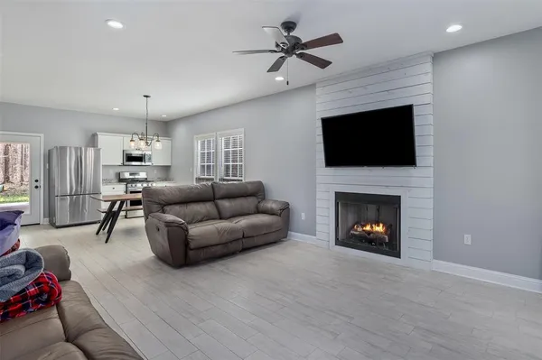 a living room with furniture a fireplace and a flat screen tv