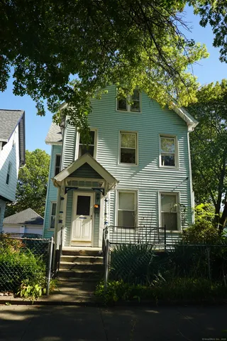 a front view of a house with yard