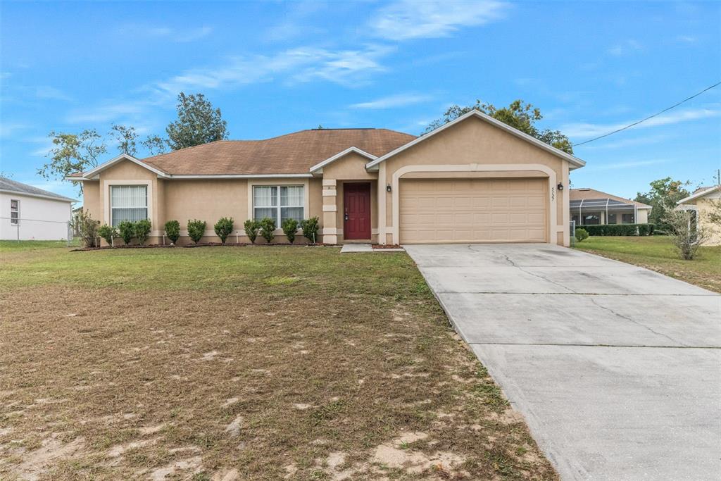 5127 Odin Street Spring Hill, FL 34608 - Photo 1 of 1 a view of a front of house with a yard