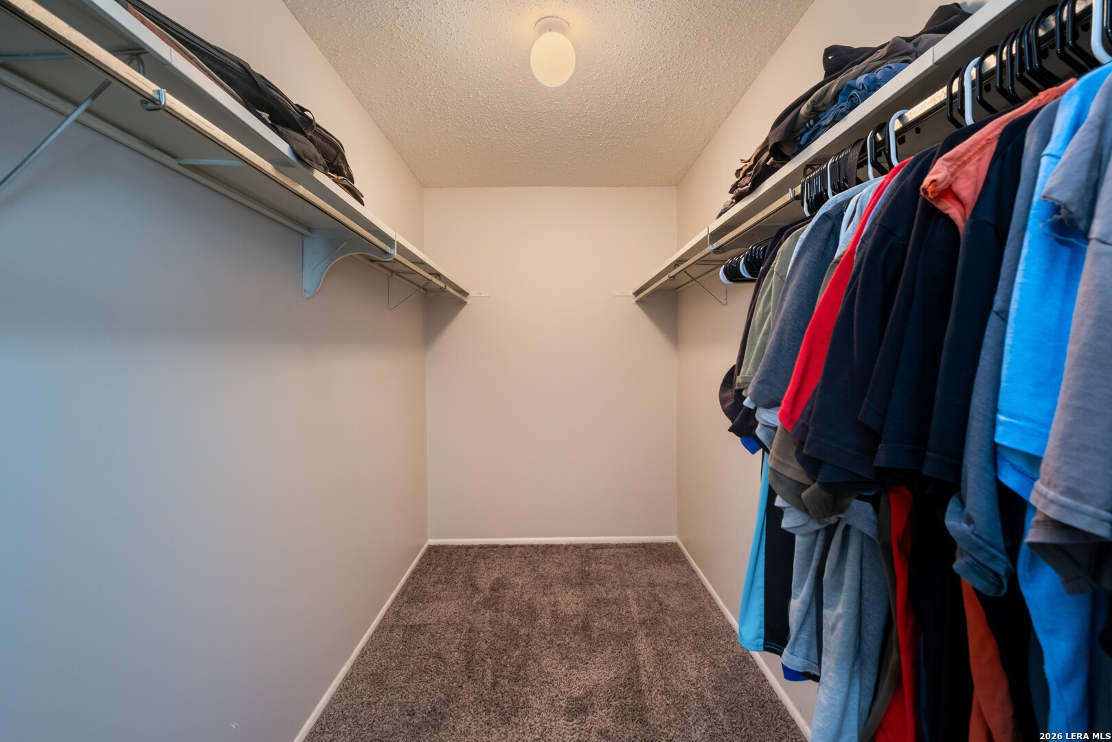 113 Friendswood Path Universal City, TX 78148 - Photo 14 of 30 a view of walk in closet with clothes and shoes
