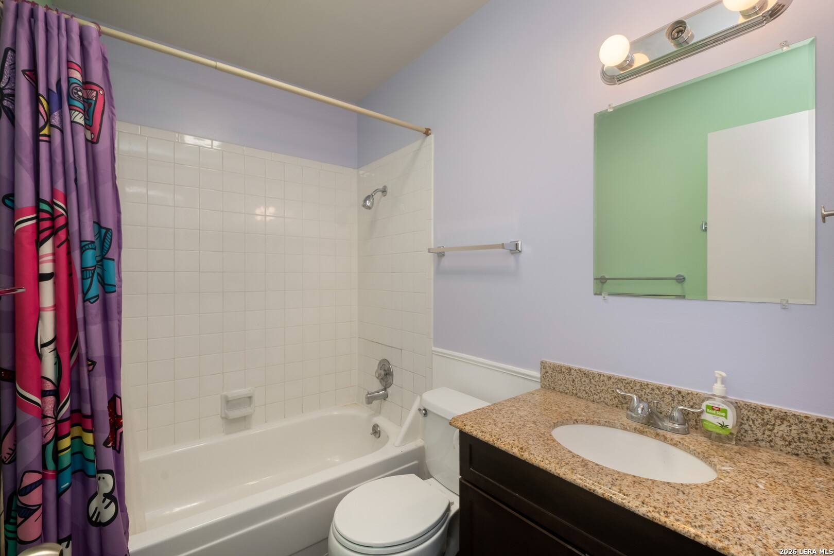 113 Friendswood Path Universal City, TX 78148 - Photo 18 of 30 a bathroom with a granite countertop sink toilet mirror vanity and bathtub